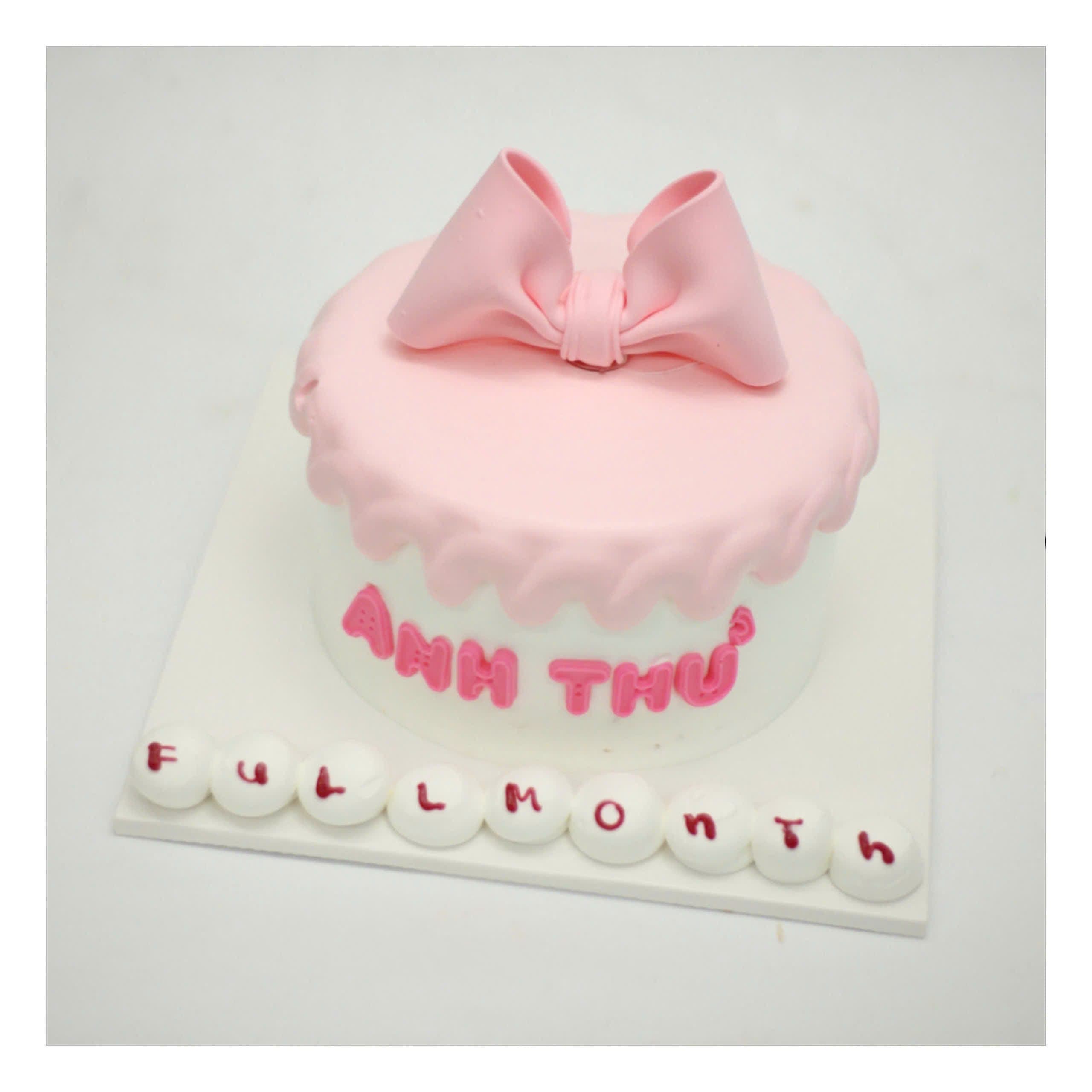 Bánh kem hồng nơ to mừng đầy tháng